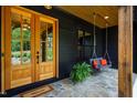 Inviting front porch features double doors, a charming swing, and stone flooring at 153 W Beech Slope Ct, Chapel Hill, NC 27517