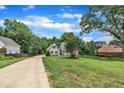 Beautifully landscaped home with a long driveway, sprawling front lawn, and mature trees, creating a private setting at 171 St. Jiles Dr, Clayton, NC 27520