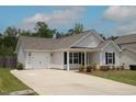 A cozy single-story home boasts an attached garage and a well-maintained lawn at 1848 Glenn St, Burlington, NC 27217
