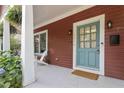 Inviting front porch with blue door, white columns, and seating area at 1916 Hart St, Durham, NC 27703