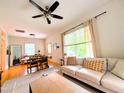Bright living room featuring hardwood floors, neutral sofa, and natural light at 1916 Hart St, Durham, NC 27703