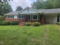 Charming brick home with a well-manicured front yard and covered porch at 218 Forestville Rd, Wake Forest, NC 27587