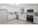 Bright kitchen with white cabinets, stainless steel appliances, and a view of the outdoors at 2905 Scuppernong Ln, Durham, NC 27703