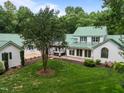 Aerial view showcasing a private backyard with patio, hot tub, and mature trees at 300 Oak Ridge Dr, Hillsborough, NC 27278