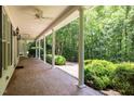 Covered porch with brick flooring and ample space for outdoor seating at 300 Oak Ridge Dr, Hillsborough, NC 27278