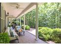 Inviting covered porch with comfortable seating and a cozy fire table at 300 Oak Ridge Dr, Hillsborough, NC 27278
