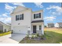 Traditional two-story home featuring white siding, black shutters, and an attached garage with concrete driveway at 316 Mimosa Ct, Sanford, NC 27332