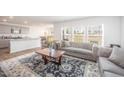 Bright and airy living room with stylish furniture, large windows, and open view to the kitchen at 316 Mimosa Ct, Sanford, NC 27332
