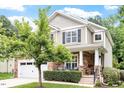 Charming two-story home features a stone facade, well-manicured lawn, and a two-car garage at 3217 Ranbir Dr, Durham, NC 27713