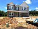 Two-story home featuring gray siding, white trim, covered porch, and an attached garage at 35 Windflower Court Ct # Homesite 9, Clayton, NC 27520