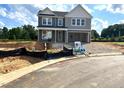 Two-story gray home with a two-car garage, covered porch, and landscaped front yard at 35 Windflower Court Ct # Homesite 9, Clayton, NC 27520