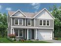 Charming two-story home with gray siding, white trim, front porch and landscaped yard at 35 Windflower Court Ct # Homesite 9, Clayton, NC 27520