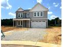 Charming two-story home with a covered front porch and a two-car garage at 35 Windflower Ct # Homesite 9, Clayton, NC 27520
