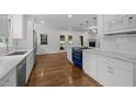 Bright, updated kitchen with white cabinets, marble counters, and a striking blue range oven at 3516 Swift Dr, Raleigh, NC 27606