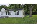 A cozy home with white siding, black shutters, and a well-maintained lawn at 426 Smith St, Burlington, NC 27217