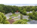 Neighborhood aerial view showing the home's location in a quiet cul-de-sac surrounded by mature trees at 427 Elm Ct, Burlington, NC 27217