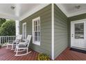 Charming porch featuring rocking chairs, wood decking and a classic entrance at 500 Weaver Mine Trl, Chapel Hill, NC 27517