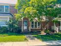 Well-maintained brick townhome with lush green lawn and mature trees providing shade and beauty at 5500 Fortunes Ridge Dr # 94C, Durham, NC 27713