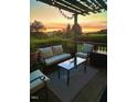 Cozy outdoor deck with pergola, string lights, and comfortable seating perfect for enjoying the sunset views at 56 Sugarhill Dr, Zebulon, NC 27597