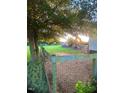 Spacious backyard with mature trees provides ample shade and privacy at 56 Sugarhill Dr, Zebulon, NC 27597