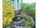 Lush landscaping surrounds a tranquil water feature adding charm to the exterior space at 56 Sugarhill Dr, Zebulon, NC 27597