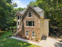 Home exterior showcasing the stone facade and a side-entry garage at 6001 Waters Way Dr, Raleigh, NC 27606