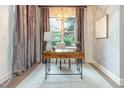 Bright home office features a wooden desk, stylish lamp, and a globe for a touch of sophistication at 618 N Boylan Ave # 520, Raleigh, NC 27603