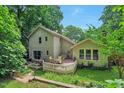 Beautiful backyard featuring a spacious deck, perfect for outdoor dining and entertaining, surrounded by lush greenery at 6701 Winding Trail Trl, Raleigh, NC 27612