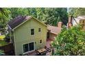 Aerial view of a home with a large deck and well-maintained landscaping, showcasing the property's backyard at 6701 Winding Trail Trl, Raleigh, NC 27612