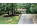 Residential home featuring a well-maintained lawn and landscaping, accented by mature trees and an attached garage at 7016 Valley Dr, Raleigh, NC 27612