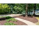 Landscaped front yard with mulch beds and a concrete walkway leading to the residence at 7016 Valley Dr, Raleigh, NC 27612