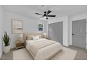 Neutral bedroom features ceiling fan, gray closet doors, and soft carpet at 802 Creech Church Rd, Kenly, NC 27542