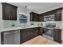 Modern kitchen features stainless steel appliances, light countertops, and stylish dark cabinets at 802 Creech Church Rd, Kenly, NC 27542