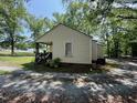 Shows the back of a one story home with vinyl siding and a small covered patio at 981 Leasburg Rd, Roxboro, NC 27573