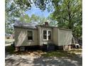 Shows the back of a one story home with vinyl siding and an exposed foundation at 981 Leasburg Rd, Roxboro, NC 27573