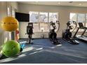 Bright gym with exercise equipment, large windows, and fitness accessories for a healthy lifestyle at 105 Slippery Elm Rd, Youngsville, NC 27596