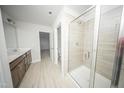 Modern bathroom featuring tiled shower with glass door and double vanity at 1108 Matterhorn Dr, Fuquay Varina, NC 27526