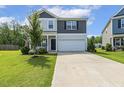 Beautiful two-story home with well-manicured lawn, gray and light gray siding, and attached two-car garage at 114 Forest Meadow Ct, Garner, NC 27529