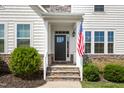 Inviting front entrance featuring a classic door, stone steps, and charming landscaping at 1154 Yorkshire Dr, Burlington, NC 27215
