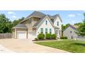 Spacious home with an attached two-car garage, well-maintained lawn, and inviting curb appeal at 1154 Yorkshire Dr, Burlington, NC 27215