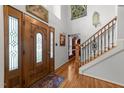 Grand foyer featuring a wood door, staircase, and beautiful hardwood floors at 116 Lost Tree Ln, Cary, NC 27513