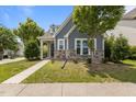 Charming home with blue siding, stone accents, inviting front entrance, and well-kept lawn at 1172 Pemberly Ave, Morrisville, NC 27560