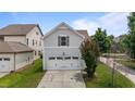 Light blue home featuring a two-car attached garage and a well-maintained lawn at 1172 Pemberly Ave, Morrisville, NC 27560