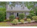 Charming home with dormer windows, complemented by manicured landscaping and a welcoming entrance at 1302 Valley Run Dr, Durham, NC 27707