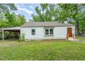 Exterior side-view of home with white siding and adjacent covered parking at 1401 Robinhood Rd, Durham, NC 27701