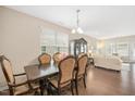 Open dining room with hardwood floors and views to the living room at 1416 Southpoint Trl, Durham, NC 27713