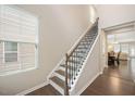 Elegant staircase features hardwood treads and ornate iron balusters at 1416 Southpoint Trl, Durham, NC 27713