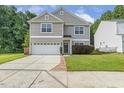 Charming two-story home showcasing neutral siding, a two-car garage, and well-manicured lawn at 160 Chandler Springs Dr, Holly Springs, NC 27540