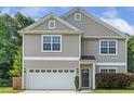 Charming two-story home showcasing neutral siding, a two-car garage, and well-manicured lawn at 160 Chandler Springs Dr, Holly Springs, NC 27540
