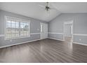 Bright living room with laminate floors, large window, and white trim, offering a welcoming space at 161 Bridgewater Dr, Erwin, NC 28339